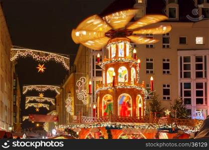 Decorated and illuminated Christmas street with carousel at night in Dresden, Saxony, Germany