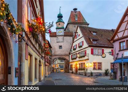Decorated and illuminated Christmas street with gate and tower Markusturm in medieval Old Town of Rothenburg ob der Tauber, Bavaria, southern Germany. Christmas Rothenburg ob der Tauber, Germany