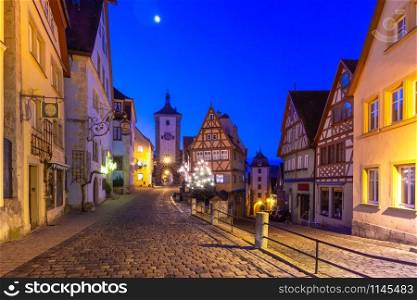 Decorated and illuminated Christmas street with gate and tower Plonlein in medieval Old Town of Rothenburg ob der Tauber, Bavaria, southern Germany. Christmas Rothenburg ob der Tauber, Germany