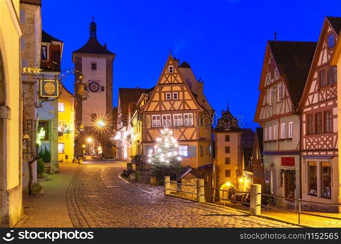 Decorated and illuminated Christmas street with gate and tower Plonlein in medieval Old Town of Rothenburg ob der Tauber, Bavaria, southern Germany. Christmas Rothenburg ob der Tauber, Germany