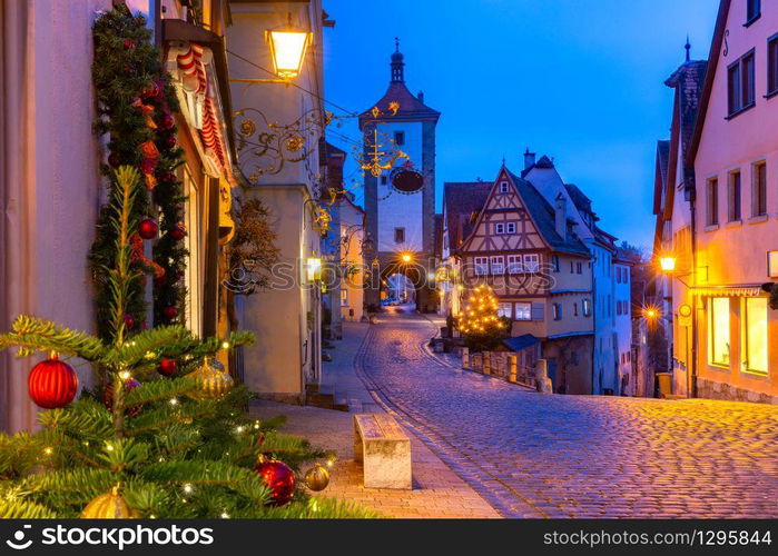 Decorated and illuminated Christmas street with gate and tower Plonlein in medieval Old Town of Rothenburg ob der Tauber, Bavaria, southern Germany. Christmas Rothenburg ob der Tauber, Germany