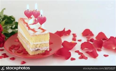 Decorated cake with candles and roses for Valentine&acute;s Day. Love and romance concept.