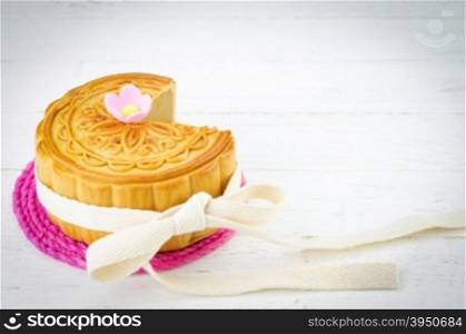 Decorated Chinese mooncake on white wood background&#xA;
