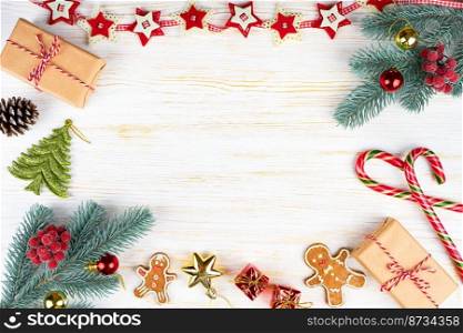 Decorated Christmas and New Year tree, gift box, garland and clock on white wooden background with copy space. Top view, flatlay.. Christmas tree on white wooden background vintage frame.