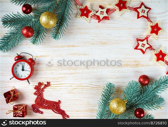 Decorated Christmas and New Year tree, toy deer, garland and clock on white wooden background with copy space. Top view, flatlay.. Christmas tree on white wooden background vintage frame.