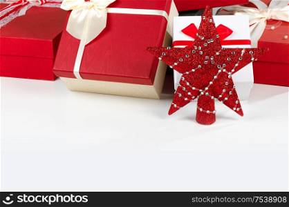 Decorated Christmas gifts and star isolated on white background. Christmas gifts and star
