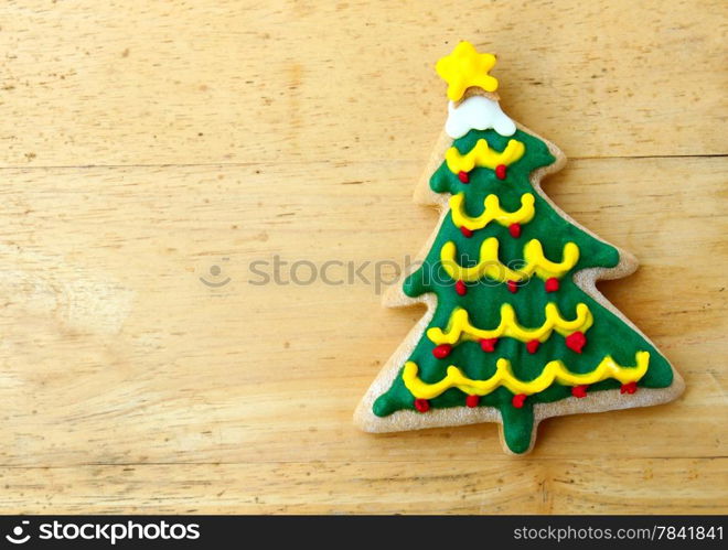 Decorated christmas gingerbread on wooden background