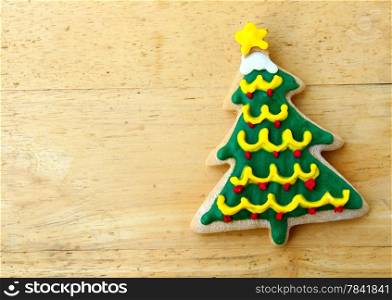 Decorated christmas gingerbread on wooden background