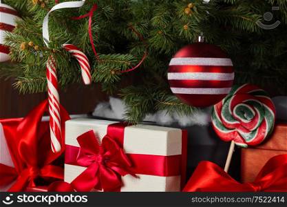 Decorated Christmas tree and gift boxes background. Decorated Christmas tree
