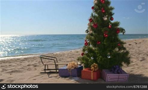 Decorated Christmas tree with gift boxes on a sandy beach