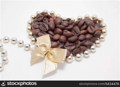 Decorated coffee beans in gold heart with bow isolated on white. do you love coffee?