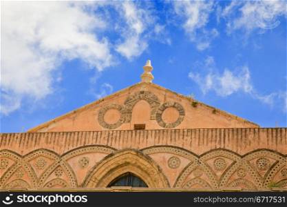 decorated frieze of ancient medieval Norman cathedral - Duomo di Monreale, Sicily, Italy