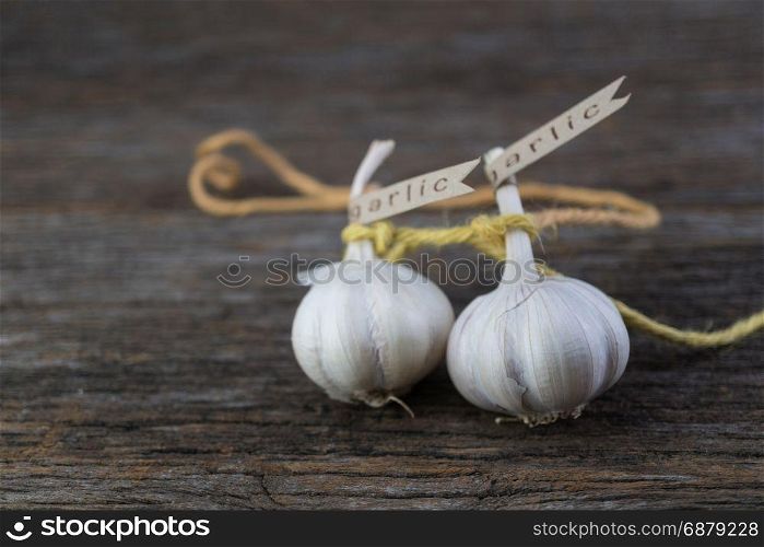 Decorated garlic bulb on vintage wood background