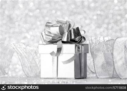 Decorated holiday gift on silver background