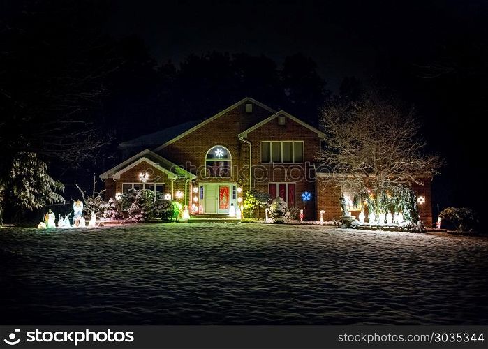 Decorated house for Christmas at night. Decorated house for Christmas at night covered in snow