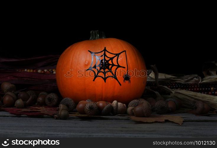 Decorated pumpkin for Halloween holiday with dark background setting