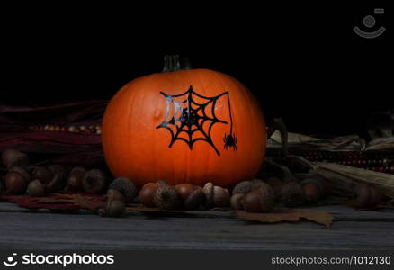 Decorated pumpkin for Halloween holiday with dark background setting