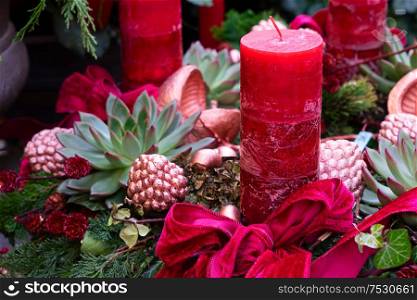 Decorated red advent candle with bow, christmas market shop in Vienna. Decorated advent candles