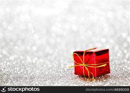 Decorated red holiday gifts on silver background