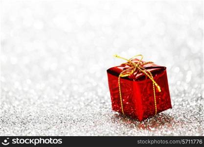 Decorated red holiday gifts on silver background
