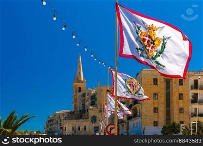 Decorated street in old town of Valletta, Malta. Festively decorated street with flags of all the Grand Masters of the Sovereign Military Order of Malta in the old town of Valletta, Malta