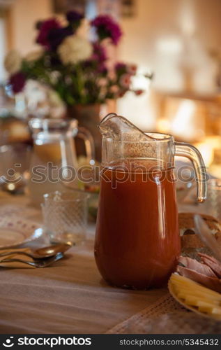 Decorated table with jug of juice. Decorated table with jug of juice on foreground