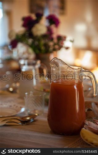 Decorated table with jug of juice. Decorated table with jug of juice on foreground