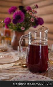 Decorated table with jug of juice. Decorated table with jug of juice on foreground