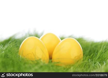 Decorated yellow easter eggs in spring grass