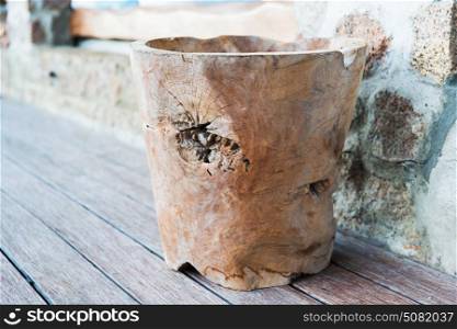 decoration and objects concept - outdoor handmade wooden bowl or vase on terrace floor. outdoor wooden bowl or vase on terrace floor
