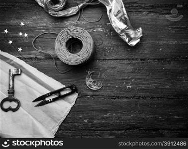 Decoration elements for craft on old wooden table. Decorator workplace. Black and white photo