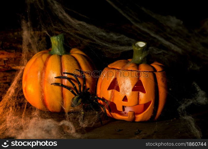 decoration for the hallowen celebration with pumpkins, spiders, candles on rustic wood. decoration for the celebration of hallowen with pumpkins, spiders, candles