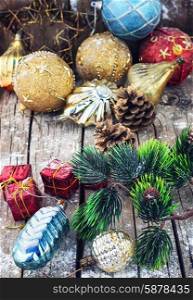 Decoration for the new year. Christmas decorations under the branches of fir tree on snowy wood plank