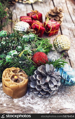 Decoration for the new year. Christmas decorations under the branches of fir tree on snowy wood plank