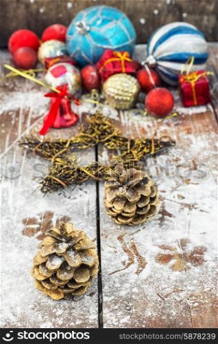 Decoration for the new year. Two pine cones on the background of snow-covered Christmas ornaments