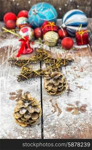 Decoration for the new year. Two pine cones on the background of snow-covered Christmas ornaments