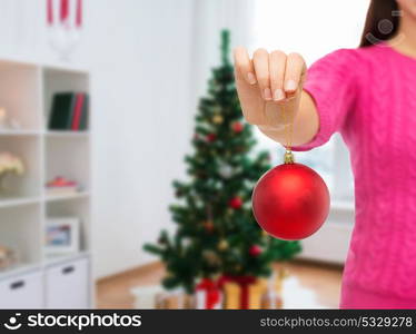 decoration, holidays and people concept - close up of woman hand holding christmas ball. close up of woman hand with christmas ball