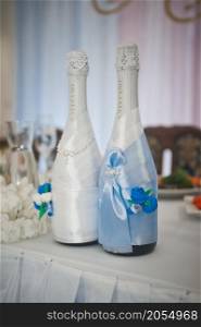 Decoration of champagne bottles for a wedding.. Bottles of champagne in the costumes of the newlyweds 2769.