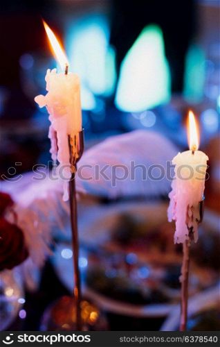 decoration of tables with burning candles, decor in shades of black, red and white