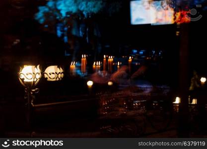 decoration of tables with burning candles, decor in shades of black, red and white