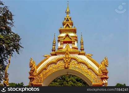 Decoration on the gate of Wat Khu Kum with the statues of Buddha, Naga, and Garuda in Muang District, Lampang Province, Thailand.