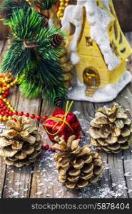 Decorations for Christmas. Christmas ornaments and pine cones on wooden background.Photo tinted.