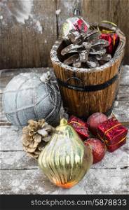 Decorations for Christmas. wooden tub with pine cones and Christmas decorations and ornaments.