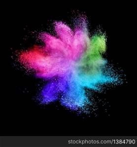 Decorative abstract chaotic colorful powder splash or explosion on a black background with copy space.. Rainbow powder splash or burst on a black background.