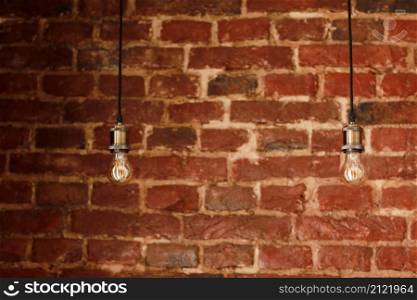Decorative antique edison style light bulbs against brick wall background.. Decorative antique edison style light bulbs against brick wall background