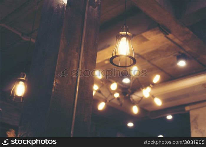 Decorative antique edison style light bulbs against cafe wall background
