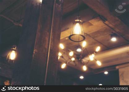 Decorative antique edison style light bulbs against cafe wall background