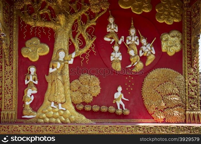 Decorative bass relief on a temple exterior at Wat Phra That Lampang Luang temple complex near Lampang in northern Thailand.