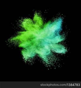 Decorative chaotic multicolored powder burst or explosion on a black background with copy space.. Abstract multicolored powder or dust splash on a black background.