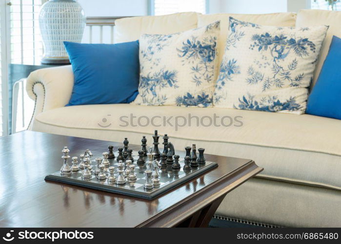 decorative chess board with chess pieces in luxury living room interior